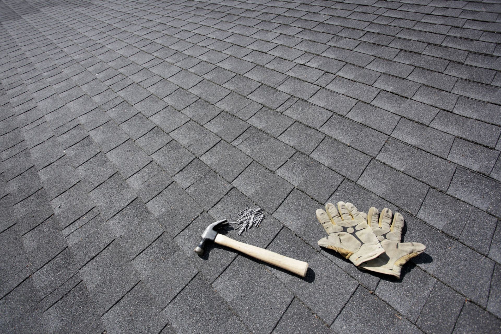 A roofer repairing a damaged roof in Ogden, addressing leaks and structural issues to maintain the home’s protection.