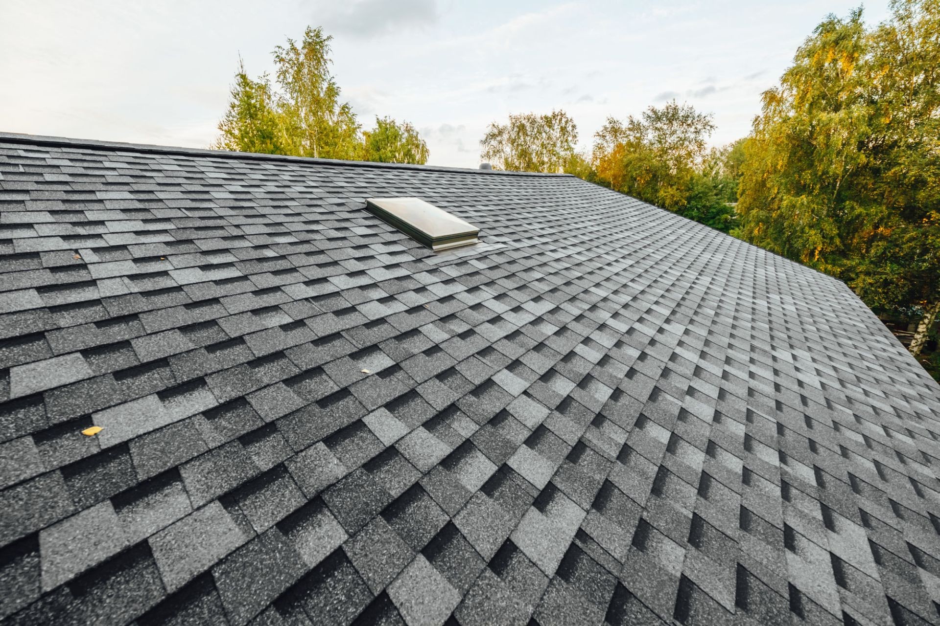 A roofer conducting repairs on a roof, securing shingles while performing preventative maintenance to extend the roof’s lifespan and protect the home from future damage.