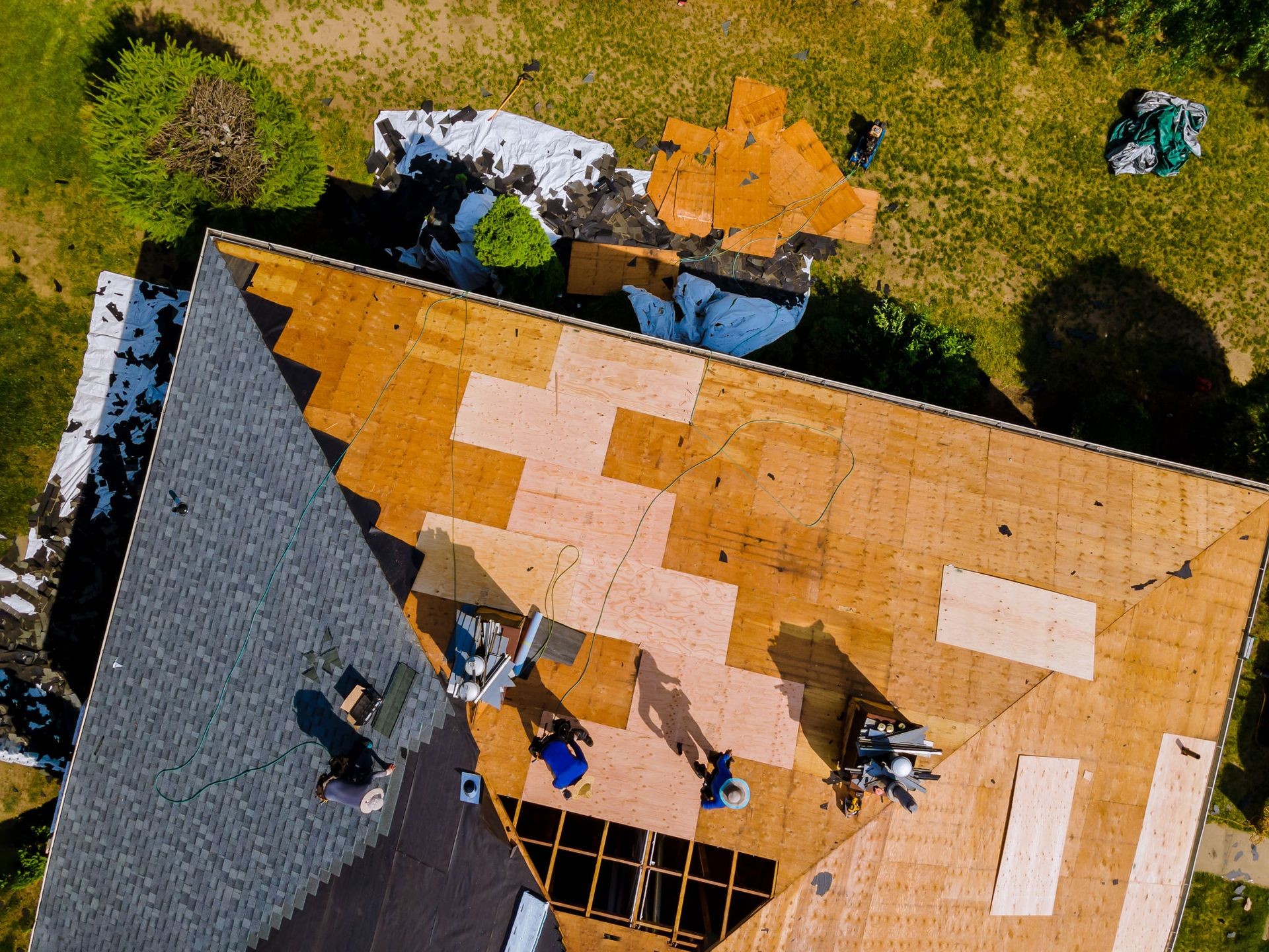 Roofing professionals installing durable roofing materials on a home in Ogden for lasting protection.